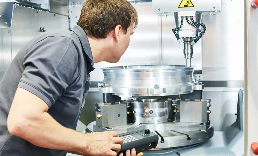 Man operating metal machine