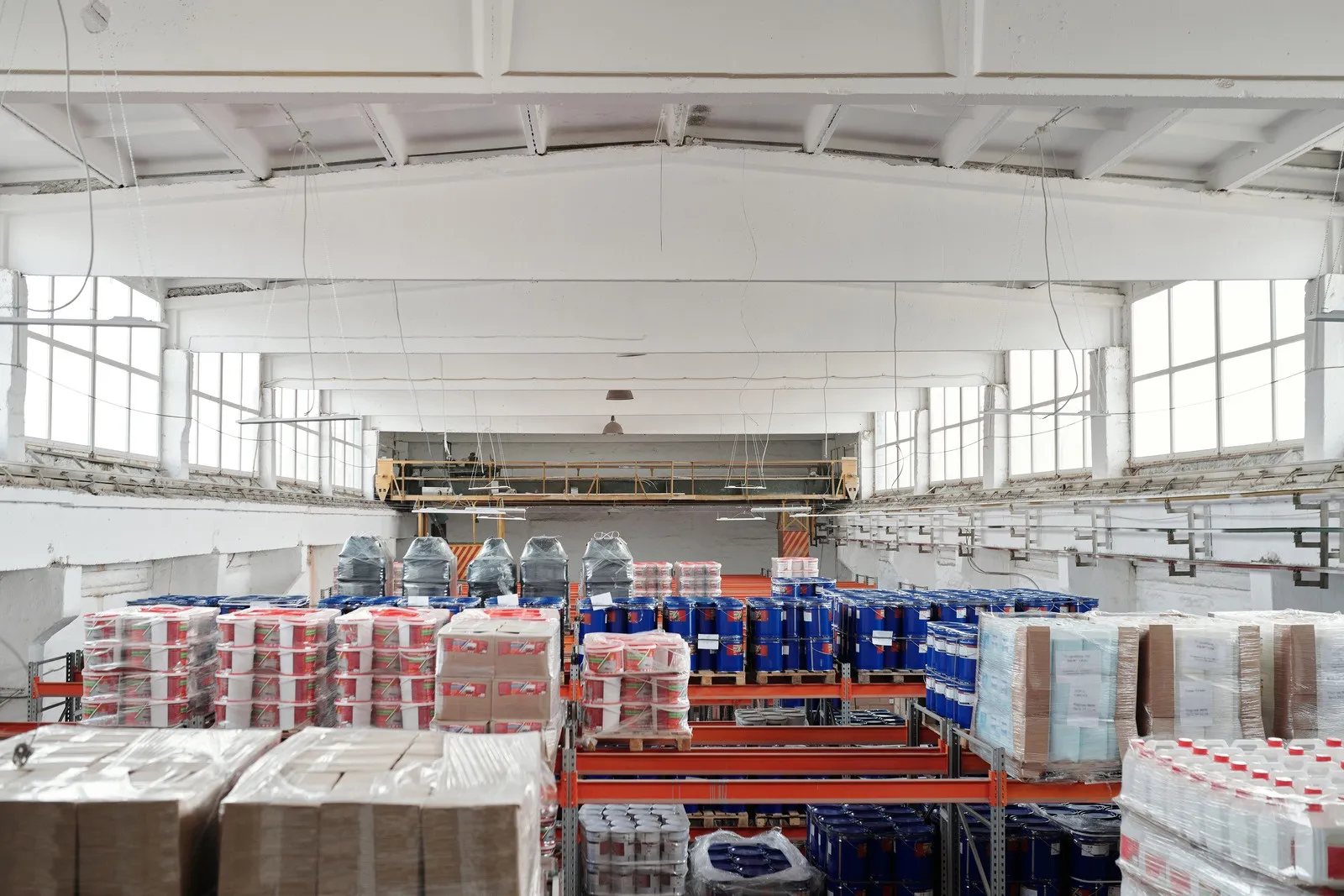 Industrial warehouse interior with palletized goods on steel racking systems