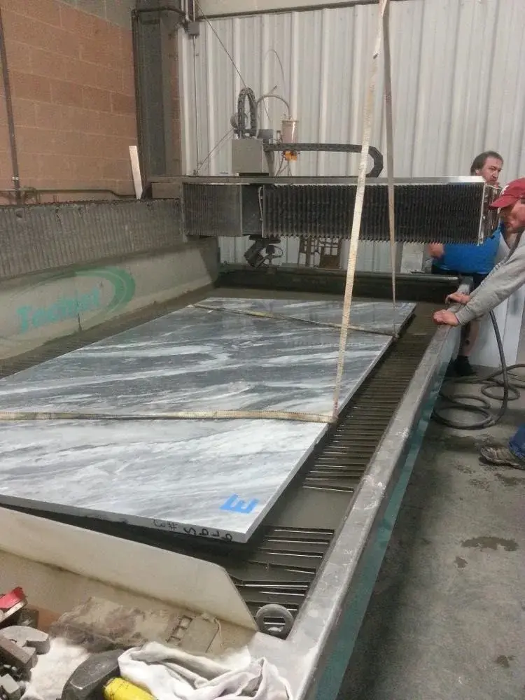Waterjet machine cutting stone slabs for non-metal fabrication