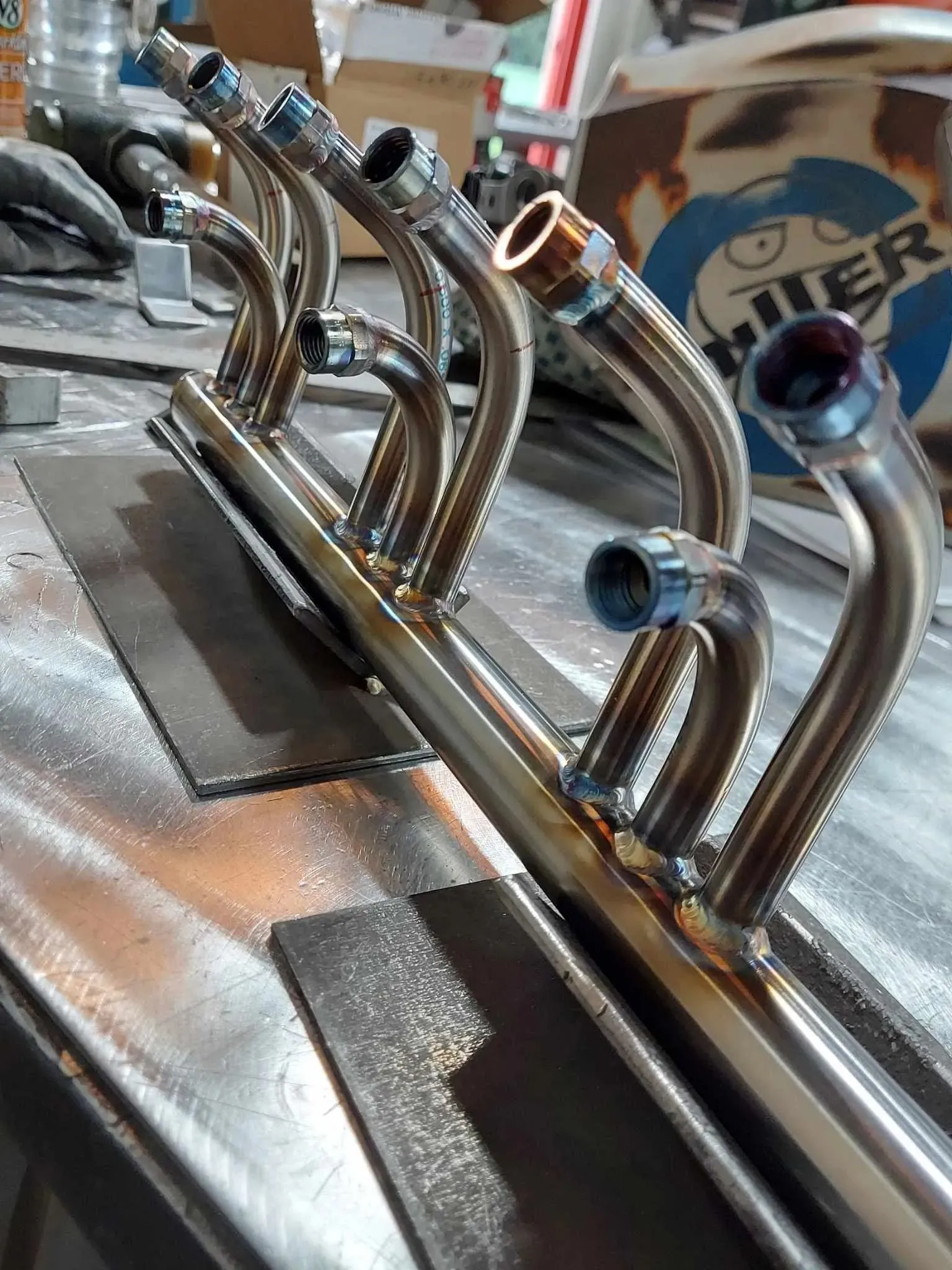 Row of polished stainless steel bent tube assemblies with fittings